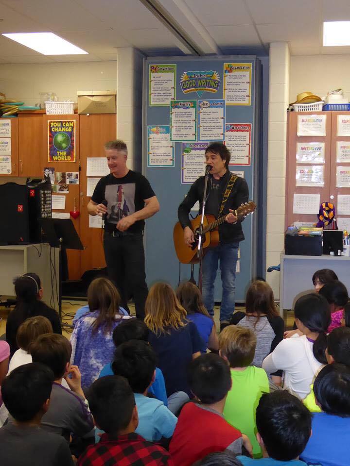 Scott Graham (left) and Gord Deppe, lead singer of The Spoons, presenting the Kids 4 Kids anti-bullying message at Joshua Creek Public School